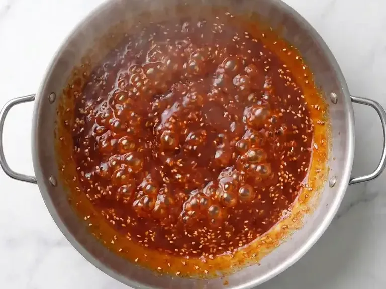 Yangnyeom sauce simmering in a wok for Korean fried chicken