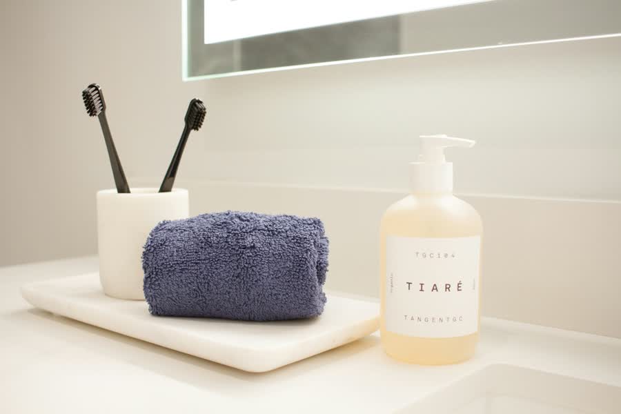 Toothbrushes in a cup on a bathroom counter, a reliable daily anchor for habit stacking