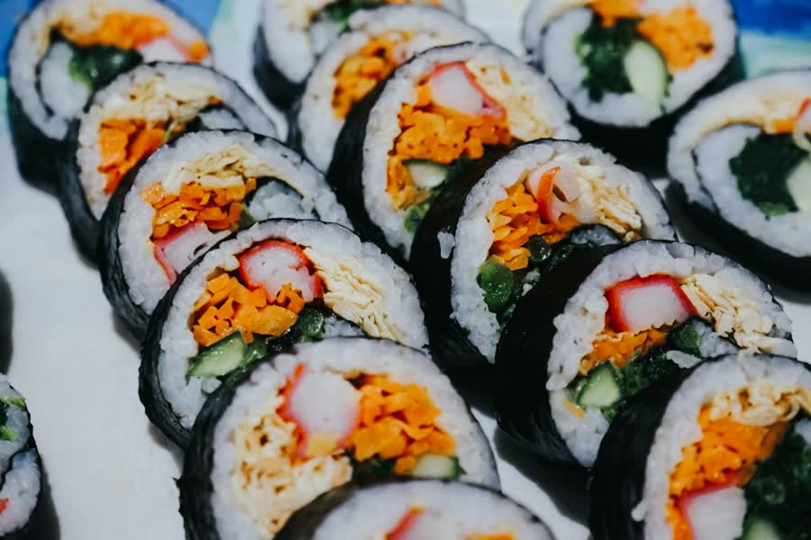 kimbap recipe sliced Korean seaweed rice rolls with carrot egg and crab stick filling